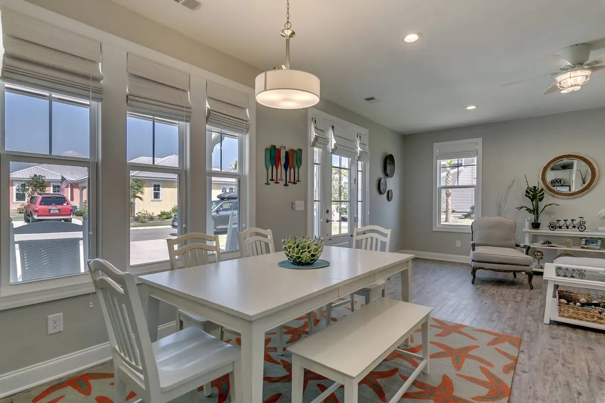 A welcoming dining area with a stylish dining table, elegant light fixture, and decorative wall art. The setting invites social gatherings, family meals, or casual brunches with friends.